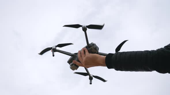 Low View To Quadcopter Tacking Off From Male Hand