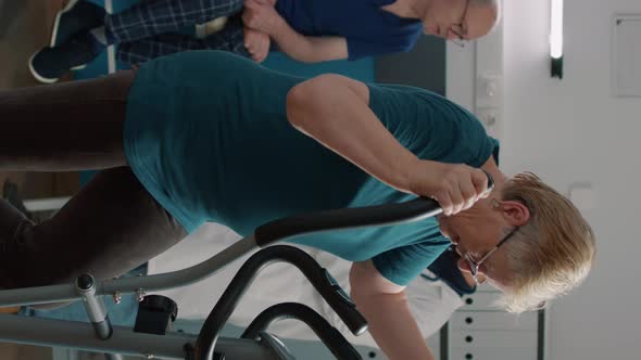 Vertical Video Portrait of Senior Woman Doing Physical Therapy on Stationary Bicycle