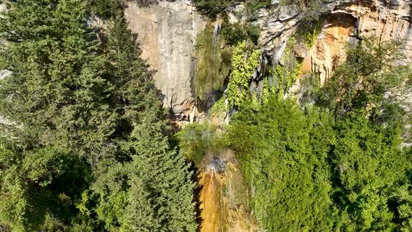 A small waterfall in the mountains aerial view 4 K