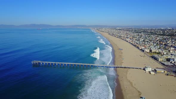 Aerial drone uav view of a pier over the beach and ocean.