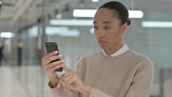 Creative African Woman Using Smartphone Browsing Internet