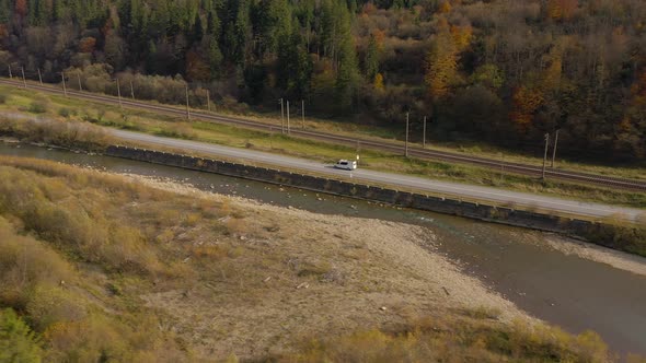 View From the Height on the Autumn Landscape - River, Railway, Forest on a Mountainside, Cars on the