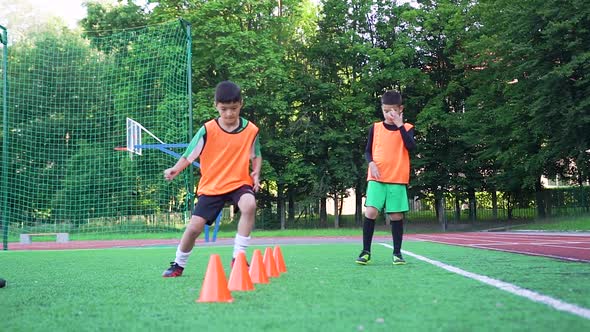 Football Players in Sportswear Doing Running Exercises During Workout on the Football Field 