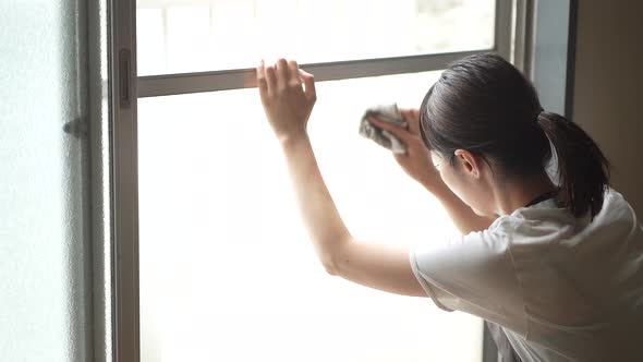 A woman cleaning the screen door