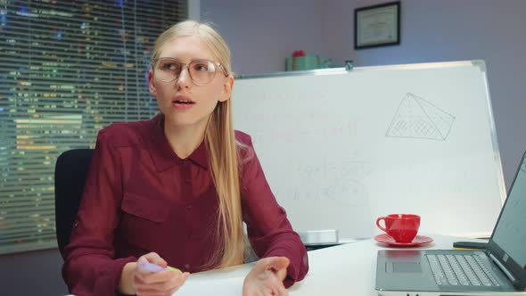 Pretty Blonde Woman Teaching By Speaking to the Camera