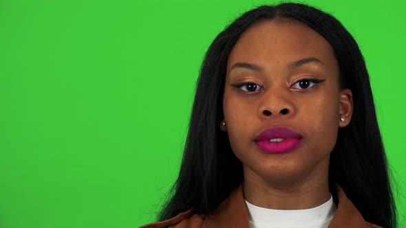 A Young Black Woman Talks To the Camera - Face Closeup - Green Screen Studio