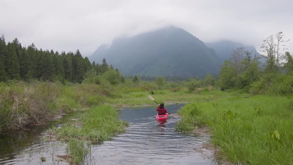 Adventure Caucasian Adult Woman Kayaking in Red Kayak