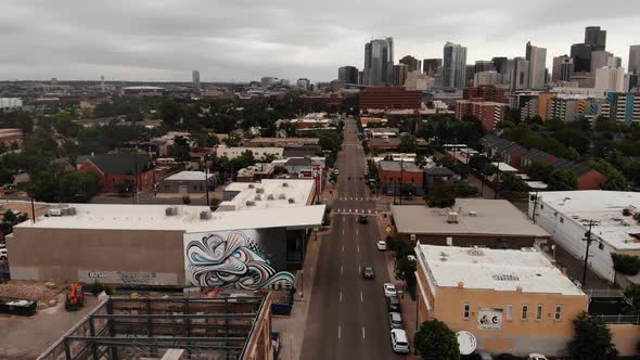 A rising pan along Santa Fe Blvd just south of Denver capturing the skyline on a gloomy day