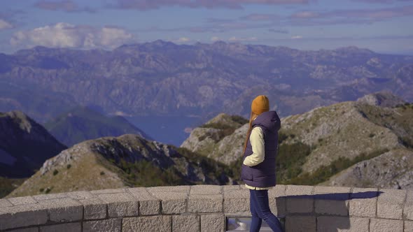 A Young Woman Traveler Visits the View Point on the Top of the Lovcen Mountain