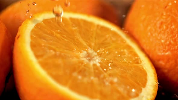 Super Slow Motion on the Slice of Orange Droplets of Orange Juice