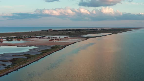 Flight from above on a quadcopter over the sea after sunset.