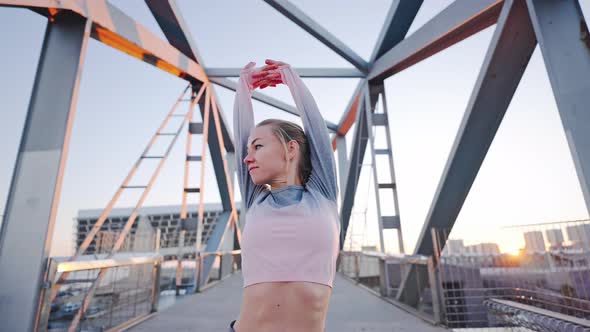 Slim Flexible Millennial Woman Athlete Exercising Warming Up on Bridge