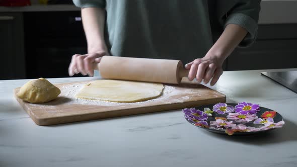 Woman making cookies with Primula petals