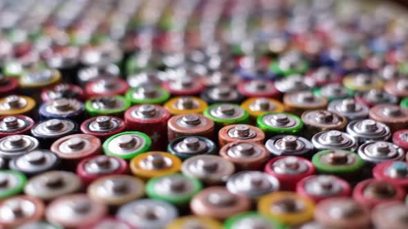 Used Batteries are Stacked in the Center Types AAA AA 9Volt Top View Background