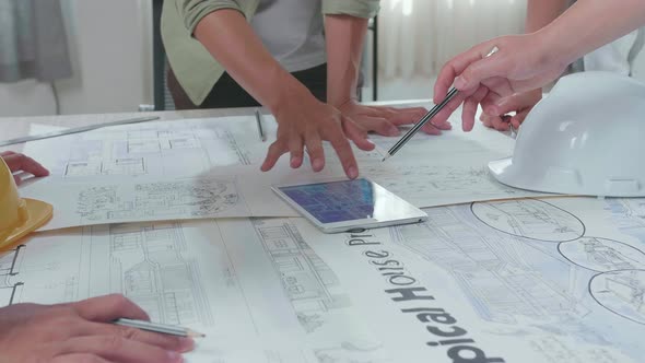 Close Up Of Group Of Asian Engineers Discuss About Work On The Tablet At The Office