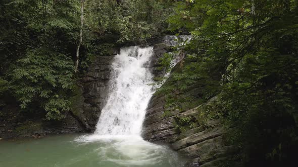 Incredible shot of a powerful waterfall in the jungles of Costa Rica