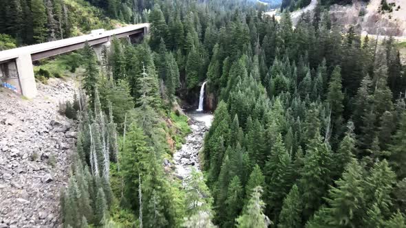 Tracking over Interstate 90 and Franklin Falls State Park, revealing a beautiful waterfall, aerial
