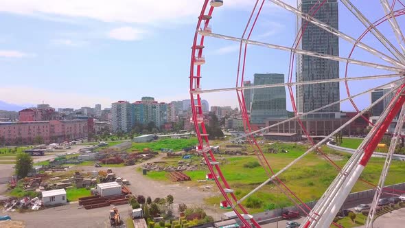 Aerial photography of a drone flying around a Ferris wheel on the seashore