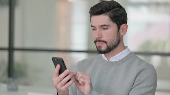 Portrait of Young Man Using Smartphone