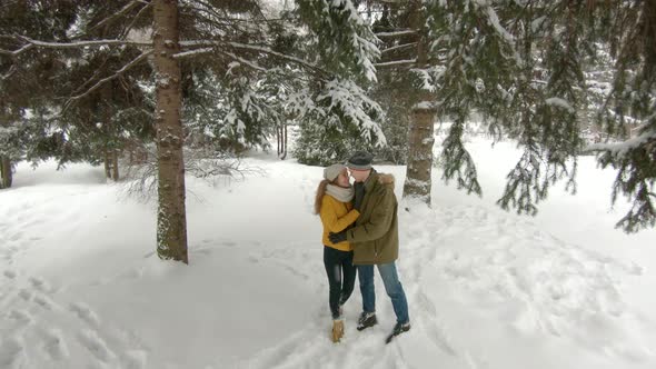 Young couple hugging in winter park