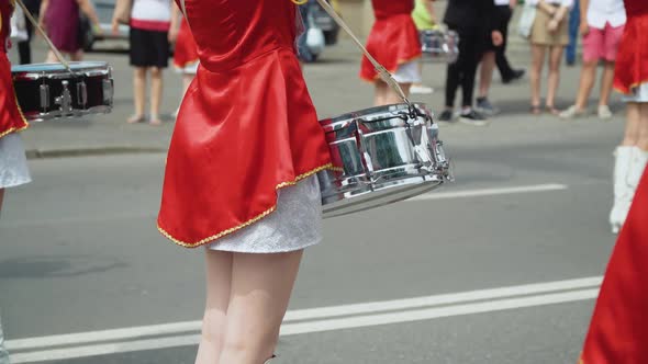 Street Performance of Festive March of Drummers Girls in Red Costumes on City Street