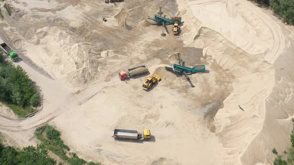 Drone flight over a bulldozer in the open cast mine. Sand mine. Aerial view