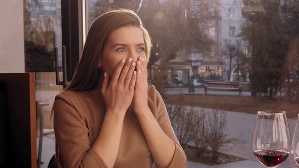 Close Up Shot of Young Surprised Woman Looking at Table During Date in Cafe Slow Motion