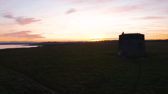 A beautiful sunset over Rush, Ireland. Empty fields with Martello tower beside the Irish sea.