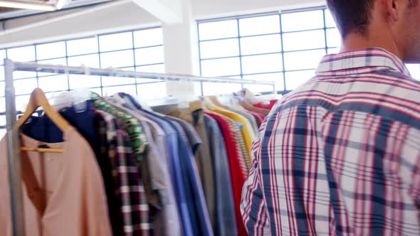 Volunteers arranging clothes on clothing rack