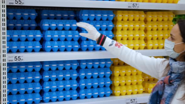 Female in Protective Mask Choosing Eggs in Store