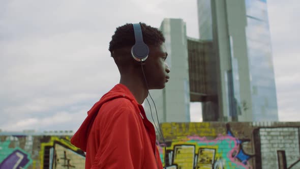 Young man walking with headphones