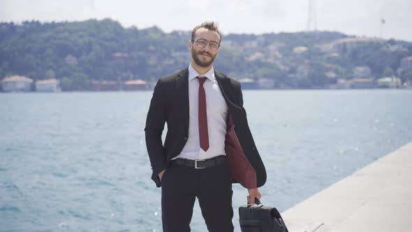 Confident businessman. He is looking at the camera.