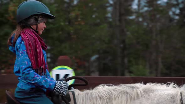 A Little Girl Enjoying Horse Riding