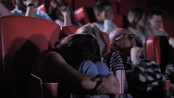 Scared Teen Friends Watching Horror in Cinema