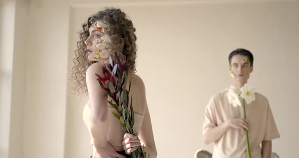 Tendet Young Couple with Floral Make Up Pose in Studio