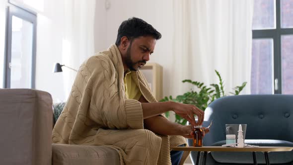 Sick Man Pouring Antipyretic Medicine To Spoon