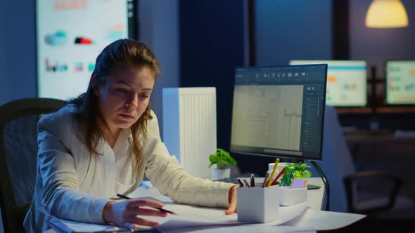 Overworked Woman Architect Analysing and Matching Blueprints