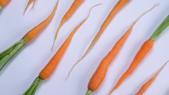 Rotating Young Carrot on White Background Healthy Food Concept Loop Trendy Vegetable Background