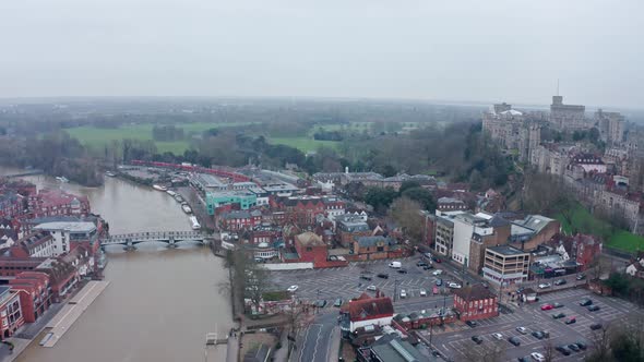 Wide aerial drone shot of thames river connecting Eton and Windsor