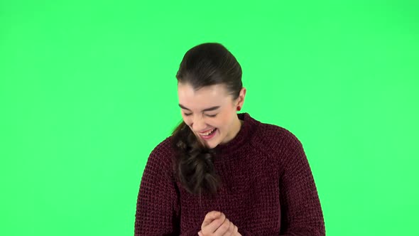 Girl Listens Carefully Then Bursts Into Laughter. Green Screen
