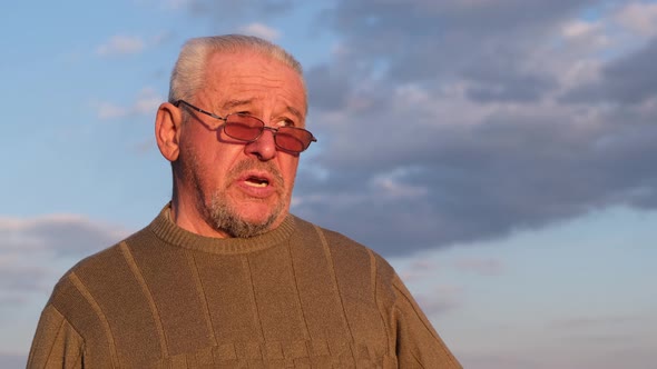 An old grandfather in depression talks about his health problems on camera.