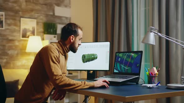 Young Engineer in His Home Office Working on Developing a New Turbine