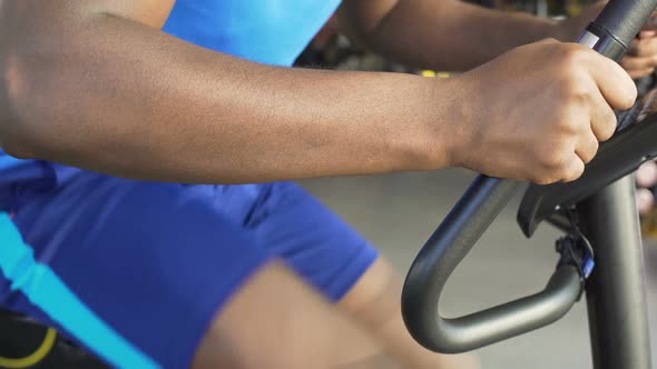 Athletic Male Riding a Stationary Bike in the Fitness Club, Sport and Health