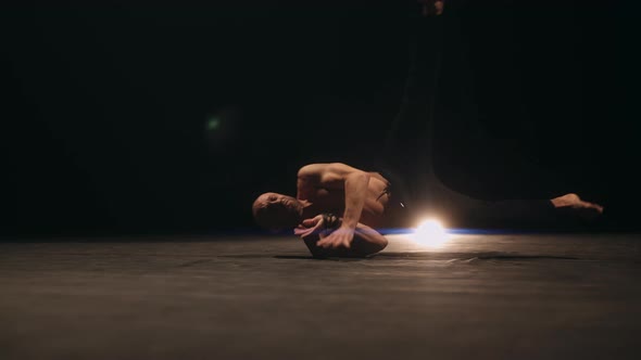 A Choreographer is Break Dancing on Stage