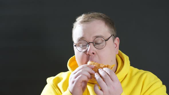 Hungry Overweight Man Eating Hamburger