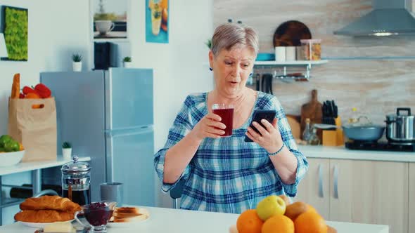 Senior Woman Using Mobile Gadget