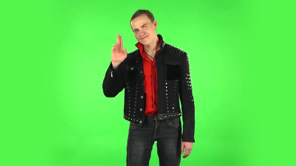 Guy Coquettishly Smiling, Waving Hand and Showing Gesture Come Here. Green Screen
