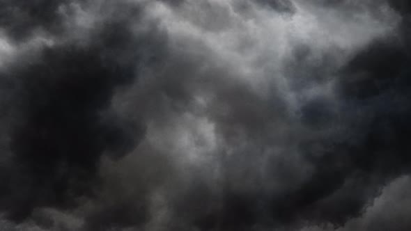 4k point of view, inside a dark cumulonimbus cloud in dark sky.