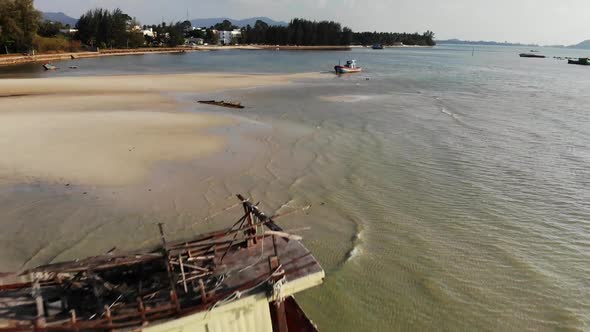 Fishing Ship on Sand Coast Near Water. Old Deserted Rusty Fishing Boat on Sand Shore Near Sea in