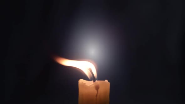 Simple candle flame flickering on dark background